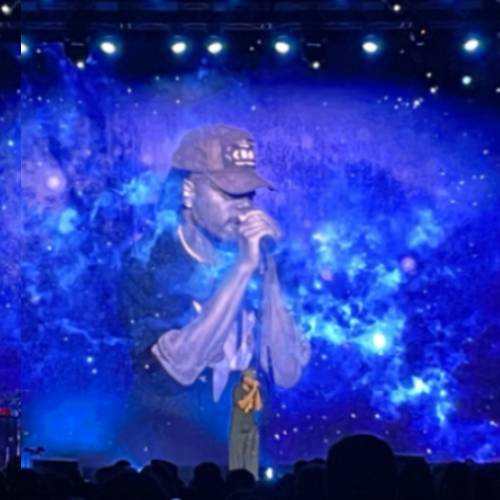 video wall displaying a space graphic and singer