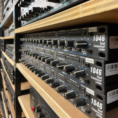 shelf full of dbx 1046 quad compressor limiter