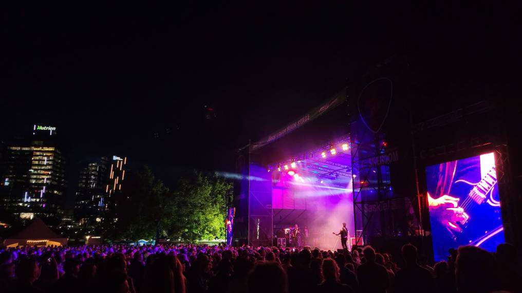 a Crowd facing a stage listening to a band